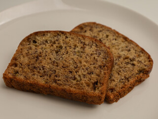 slice of banana bread on white background