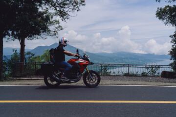 Biker riding along mountain road with GPS and smartphone mounted, integrating navigation systems...