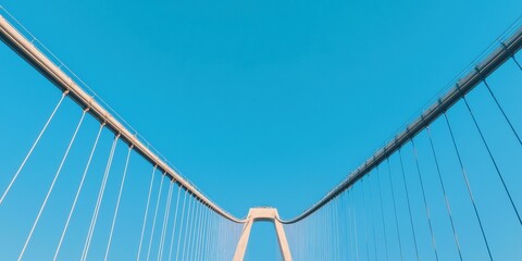 Construction infrastructure highway progress concept. Modern suspension bridge against a clear blue sky.