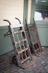 Two old rusty metal handcarts at an antique railway station