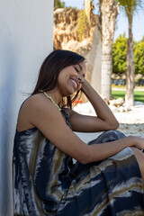 Fototapeta premium Brunette woman sitting on the floor posing in summer clothes.