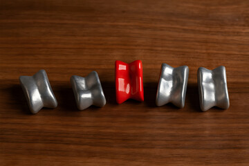 Vintage metal knucklebones game on a wooden table.