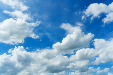 White fluffy clouds in blue sky on sunny day