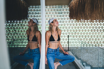 Energetic young woman climbs stairs barefoot with phone in hand, portraying digital mobility, tech...