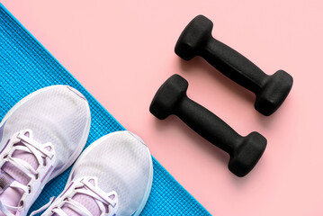 Top view of black dumbbells,fitness mat and sneakers. Sport and fitness concept