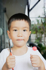 This boy lost his teeth from eating sweets and nibbles, which is likely due to natural loss. His smile reveals gaps where teeth used to be, giving him an attractive, young, and cheerful appearance.