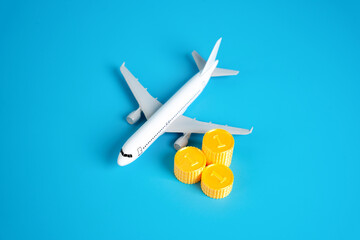 Passenger plane and stacks of coins. Finance in the airline industry. Profits, income and taxation....