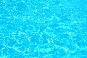 Vibrant turquoise pool water surface glowing under sunlight
