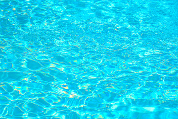 Vibrant turquoise pool water surface glowing under sunlight