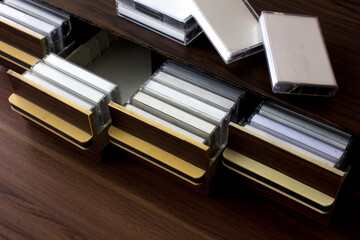Some blank white label tape cassettes in a wooden cassette tape storage drawers. Many vintage...
