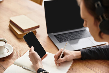 Young man enjoys a cozy study session at home with coffee and technology
