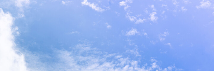 Clear blue sky with a few clouds. The sky is very bright and the clouds are scattered throughout