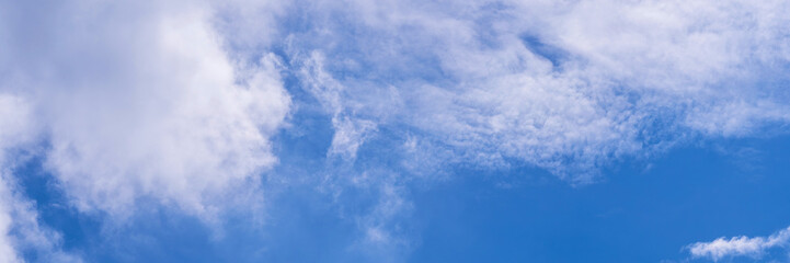 Clear blue sky with a few clouds. The sky is very bright and the clouds are scattered throughout