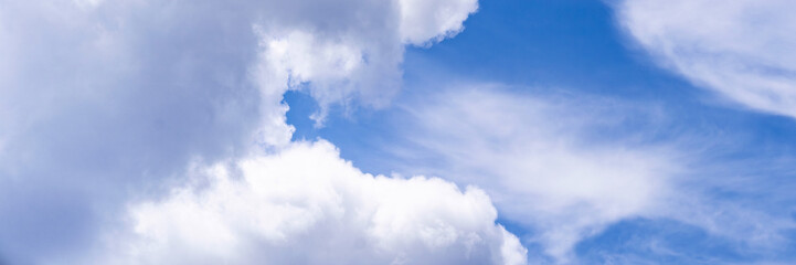 Clear blue sky with a few clouds. The sky is very bright and the clouds are scattered throughout