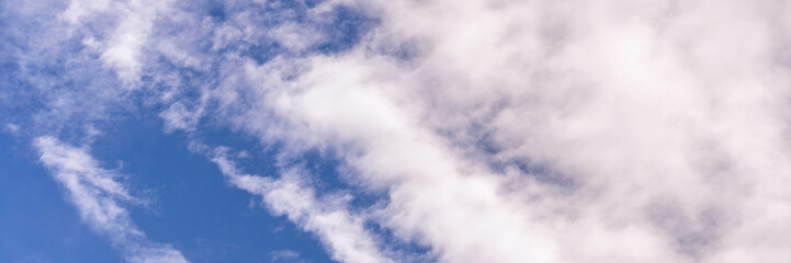 Clear blue sky with a few clouds. The sky is very bright and the clouds are scattered throughout