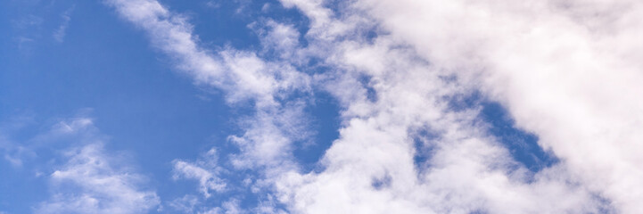 Clear blue sky with a few clouds. The sky is very bright and the clouds are scattered throughout