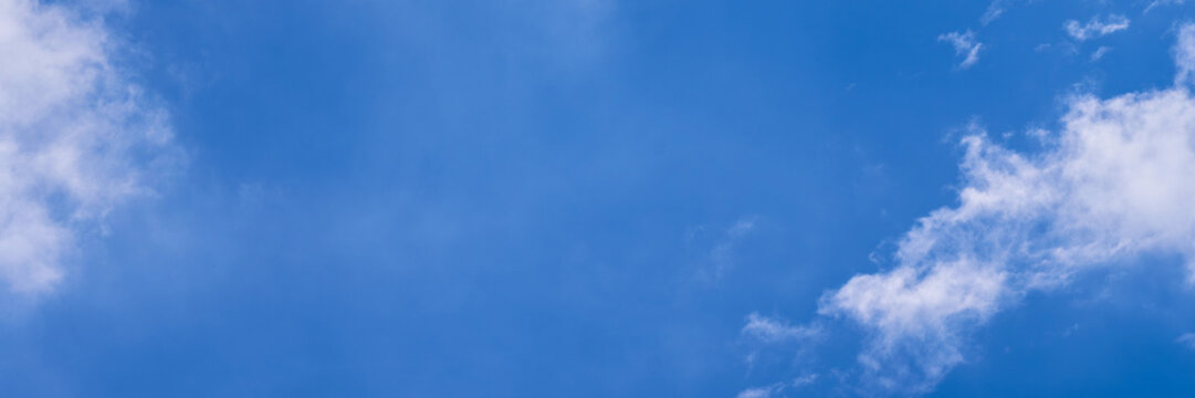 Clear blue sky with a few clouds. The sky is very bright and the clouds are scattered throughout