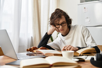 Young man enjoys cozy reading time at home with pastries and laptop nearby