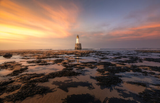 Rattray head lighthouse at sunset in Scotland