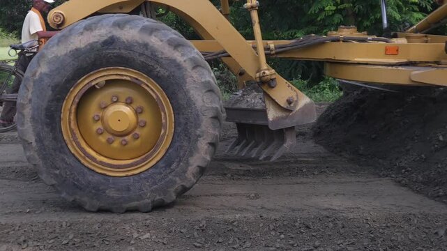 Construction site, large yellow heavy machinery like excavators, road building, and land development activities under the pressure of modern engineering and transportation demands.