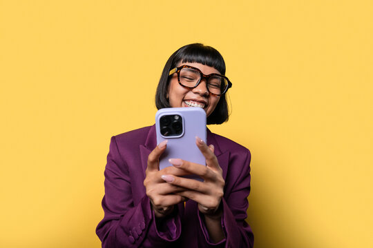 Hispanic woman smiling while using her smartphone