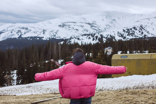 Exploring snowy mountains in a pink jacket