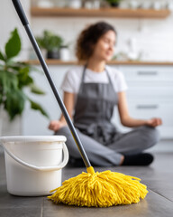 A woman takes a moment of serenity while cleaning, achieving a state of mindfulness and peace amidst the demands of everyday life.