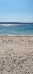 A view from the sandy Poli Mora beach in Selce, with shimmering turquoise sea in the foreground and...
