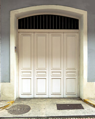 white vintage, wooden door in a stone wall