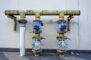 Examining Industrial Pipes and Valves System Attached to Exterior Wall