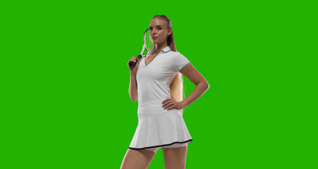 Woman tennis player playing tennis on green screen background.