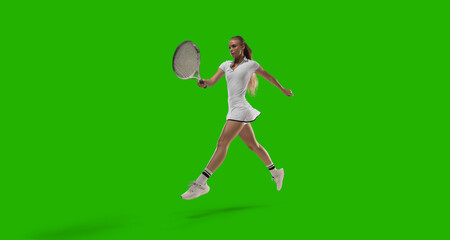 Woman tennis player playing tennis on green screen background.