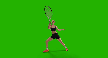 Woman tennis player playing tennis on green screen background.