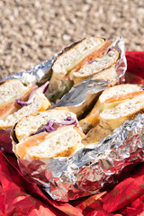 Freshly made bagels filled with smoked salmon, cream cheese, red onions, and possibly cucumbers or...