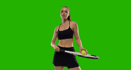 Woman tennis player playing tennis on green screen background.