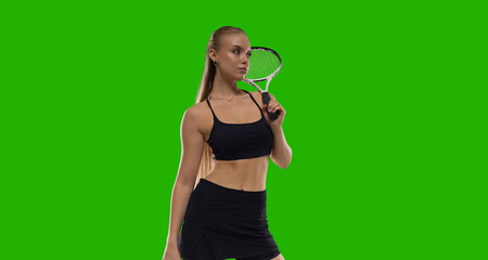 Woman tennis player playing tennis on green screen background.