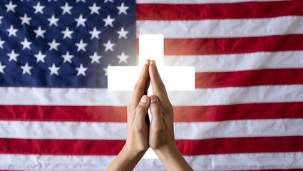 Praying hands before glowing cross and american flag