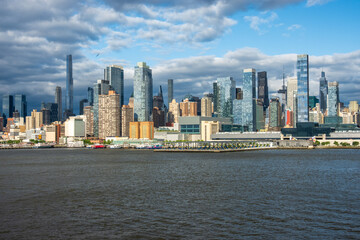 New York, NY - 18 May 2025: Tall office and apartment buidlings along the waterfront in Manhattan by Pier 78 and ferry terminal