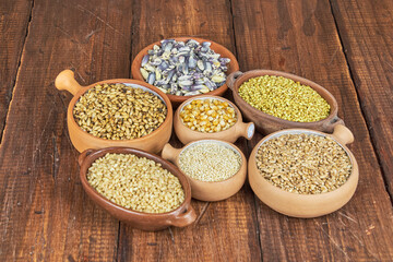 Whole grains concept. A colorful mix of whole grains: wheat, corn, and quinoa. Ingredients for a healthy diet, selective focus.