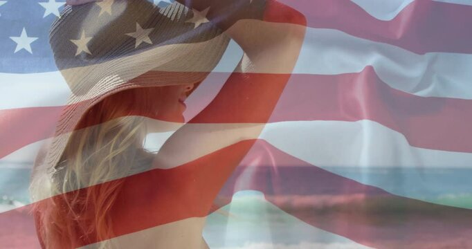 Flag overlay appearing prompts beachgoer lifting hat brim shading eyes while gazing ocean
