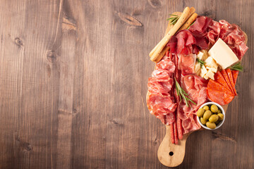 Charcuterie board. Antipasti appetizers of meat platter with salami, prosciutto crudo or jamon and...