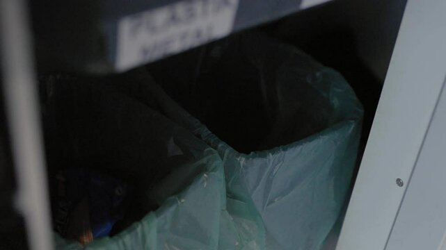 Sorting trash bins at home. Household waste sorting in the kitchen cabinet.	