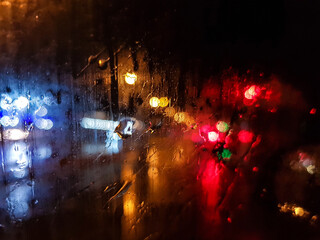 Attractive night photo of lights through a car window with raindrops.