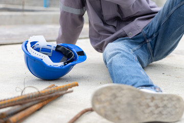Worker lies on construction site floor with safety helmet suffer from accident