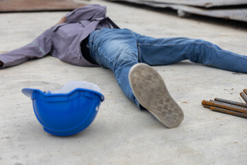 Worker lies on construction site floor with safety helmet suffer from accident