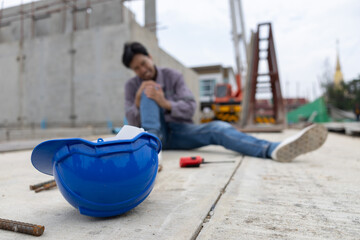 Worker lies on construction site floor with safety helmet suffer from accident