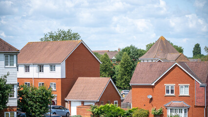 English townhouses with tiled roof and brick wall showing classic residential architecture in bright sun