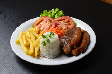 Picanha grelhada, servida com batatas fritas e salada