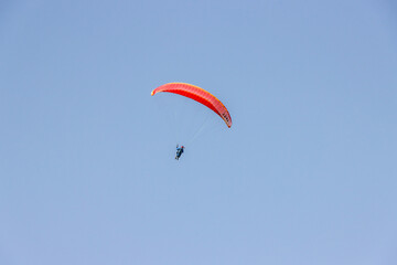 a man flies a paraglider in the sky