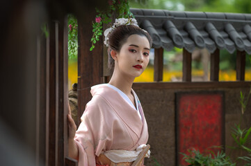 Portrait young geisha in traditional kimono or yukata costume in Japanese style house